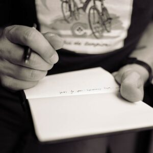 person writing on notepad